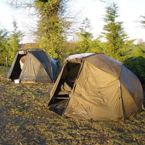 Biwy et bivouac installés au bord d'un étang pour une session carpe